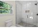 Modern bathroom with glass-enclosed shower, white tile, and updated fixtures at 5328 Oaktree Dr, Gastonia, NC 28052