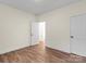 Empty bedroom with hardwood floors, a window, and two doors at 5328 Oaktree Dr, Gastonia, NC 28052