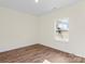 Light filled room with wood-look floors and a window view of the surrounding greenery at 5328 Oaktree Dr, Gastonia, NC 28052