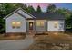 Charming front view of home with stone accents, porch, and tasteful landscaping at 5328 Oaktree Dr, Gastonia, NC 28052