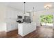 Modern kitchen with white cabinets, stainless steel appliances, and island with sink, offers backyard views at 5328 Oaktree Dr, Gastonia, NC 28052