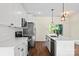 Bright kitchen with white cabinets, stainless steel appliances, and a center island with a sink at 5328 Oaktree Dr, Gastonia, NC 28052