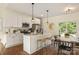 Open-concept kitchen with a center island, modern appliances, and a dining area at 5328 Oaktree Dr, Gastonia, NC 28052