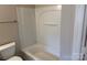Bright bathroom featuring a shower-tub with white tiling and functional towel bar at 6112 Creft Cir, Indian Trail, NC 28079
