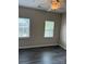 Spacious bedroom with large windows, ceiling fan, and hardwood floors at 6112 Creft Cir, Indian Trail, NC 28079