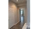 Inviting hallway leading to a bedroom with abundant natural light, showcasing an open floorplan at 6112 Creft Cir, Indian Trail, NC 28079