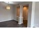 Inviting living area with dark wood flooring, fresh paint, and stylish light fixture at 6112 Creft Cir, Indian Trail, NC 28079