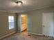 Cozy bedroom with plush carpet, a large window, and a view of the ensuite bathroom at 6218 Old Pageland Marshville Rd, Marshville, NC 28103