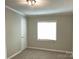 Comfortable bedroom featuring neutral walls, carpeted floors, and a bright window at 6218 Old Pageland Marshville Rd, Marshville, NC 28103