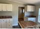 Updated kitchen with modern countertops, white cabinets, and a view of the adjacent room at 6218 Old Pageland Marshville Rd, Marshville, NC 28103