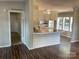 Bright kitchen featuring white cabinetry, a breakfast bar, and views into the dining area at 6218 Old Pageland Marshville Rd, Marshville, NC 28103