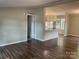 Inviting living room featuring new flooring, an open layout, and views into the kitchen at 6218 Old Pageland Marshville Rd, Marshville, NC 28103