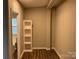 Neutral room with built-in shelving and wood-look vinyl flooring at 6218 Old Pageland Marshville Rd, Marshville, NC 28103
