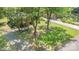 Aerial shot of a home with mature trees, a long driveway, and a spacious, grassy yard at 6616 Woodlawn Ln, Indian Trail, NC 28079