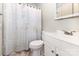 Bright bathroom featuring a shower/tub, toilet, vanity, and mirror at 6616 Woodlawn Ln, Indian Trail, NC 28079