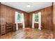 Wood paneled bedroom with hardwood floors and natural light from the windows at 6616 Woodlawn Ln, Indian Trail, NC 28079