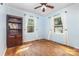 Bright bedroom with hardwood floors, two windows, and a ceiling fan at 6616 Woodlawn Ln, Indian Trail, NC 28079