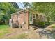 Brick home's exterior featuring access door, brick steps, and A/C units at 6616 Woodlawn Ln, Indian Trail, NC 28079