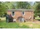 Exterior view of a brick home showing two windows and air conditioning units at 6616 Woodlawn Ln, Indian Trail, NC 28079