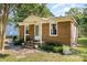 Inviting brick home with a quaint covered porch, tidy landscaping, and classic curb appeal at 6616 Woodlawn Ln, Indian Trail, NC 28079