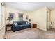 Cozy living room featuring a comfortable blue sofa, neutral walls, and ample natural light at 6616 Woodlawn Ln, Indian Trail, NC 28079