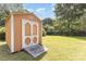 Shed featuring double doors, a wood ramp, and a manicured lawn at 6616 Woodlawn Ln, Indian Trail, NC 28079