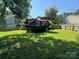 Well-maintained backyard with lush green grass, wooden fence, and a deck perfect for outdoor entertaining at 707 Regency Dr, Charlotte, NC 28211