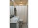 Clean and functional bathroom with updated vanity, granite countertop, and a shower-tub combination with a white curtain at 707 Regency Dr, Charlotte, NC 28211