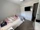 Cozy bedroom features carpet, TV, and ample storage space; perfect for a comfortable and relaxing atmosphere at 707 Regency Dr, Charlotte, NC 28211