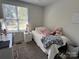 Bright bedroom features a twin bed, neutral walls, carpet and a desk at 707 Regency Dr, Charlotte, NC 28211