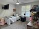 Cozy bedroom features a twin bed, neutral walls, carpet and a ceiling fan at 707 Regency Dr, Charlotte, NC 28211