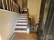 Inviting entryway featuring hardwood floors, a staircase, and an open door with glass panels at 707 Regency Dr, Charlotte, NC 28211