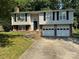 Charming two-story home with an attached two-car garage and a well-maintained lawn at 707 Regency Dr, Charlotte, NC 28211
