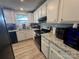 Well-lit kitchen features white cabinets, granite countertops, stainless steel appliances and tile backsplash at 707 Regency Dr, Charlotte, NC 28211