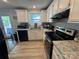 Well-lit kitchen features white cabinets, granite countertops, stainless steel appliances and tile backsplash at 707 Regency Dr, Charlotte, NC 28211