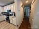 Galley kitchen featuring modern stainless steel appliances and white cabinetry with granite countertops at 707 Regency Dr, Charlotte, NC 28211