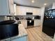 Well-lit kitchen features white cabinets, granite countertops, stainless steel appliances and tile backsplash at 707 Regency Dr, Charlotte, NC 28211