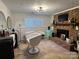 Inviting living room features a brick fireplace, tile floors, and bright windows, ideal for relaxing and entertaining at 707 Regency Dr, Charlotte, NC 28211