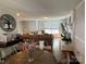 Open-concept living room features a fireplace, hardwood floors, and seamless transitions between the living and dining areas at 707 Regency Dr, Charlotte, NC 28211