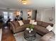 Bright living room features a large sectional sofa, a metal coffee table, and hardwood floors leading to a breakfast area at 707 Regency Dr, Charlotte, NC 28211