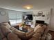 Spacious living room features a cozy fireplace, hardwood floors and a large, comfortable sectional sofa at 707 Regency Dr, Charlotte, NC 28211