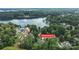 Stunning aerial view of lakefront property at 8275 Normandy Rd surrounded by lush greenery and waterfront access at 8275 Normandy Rd, Denver, NC 28037