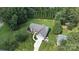 Beautiful aerial view of a well-maintained home with lush green lawn, long drive, and mature trees surrounding the property at 8275 Normandy Rd, Denver, NC 28037