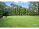 Large grassy backyard with mature trees at 8275 Normandy Rd, Denver, NC 28037