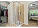 Spacious bathroom with a shower and views into the walk-in closet and the main bedroom at 8275 Normandy Rd, Denver, NC 28037