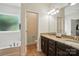 Well lit bathroom vanity with granite countertops, a soaking tub and a separate toilet area at 8275 Normandy Rd, Denver, NC 28037
