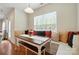 Dining nook with a built-in bench, and decorative pillows next to a sunlit window at 8275 Normandy Rd, Denver, NC 28037