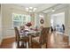 Lovely dining room with hardwood floors, chandelier, large windows, and access to other living spaces at 8275 Normandy Rd, Denver, NC 28037