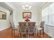 Chic dining room featuring a glass table, upholstered chairs, chandelier, and natural light, enhancing the dining experience at 8275 Normandy Rd, Denver, NC 28037