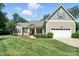 Charming home featuring a well-manicured lawn, covered front porch with columns, and attached garage with ample parking at 8275 Normandy Rd, Denver, NC 28037